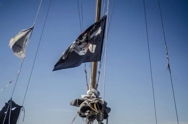 Beautiful pirate flag. Beautiful background and view of the pirate and robber black with bones and skull flag and standard day in summer.