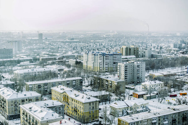 Beautiful background and view, landscape and panorama from above of the city, center and capital, streets and buildings, against the backdrop of a winter landscape with snow.