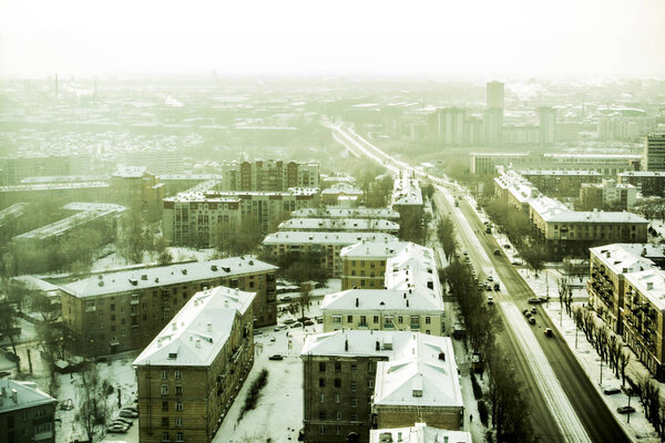 Beautiful background and view, landscape and panorama from above of the city, center and capital, streets and buildings, against the backdrop of a winter landscape with snow.