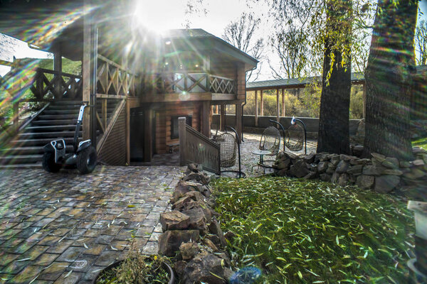 Beautiful homes and objects. Beautiful background, view, panorama, landscape of the city park, garden, public garden with wooden buildings and green areas on a summer or autumn day.