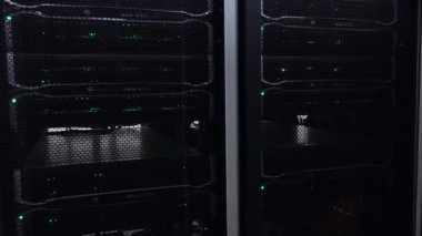Yanıp sönen LED yeşil ışıklar ile koyu modern çalışma veri sunucuları.