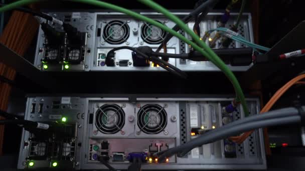 Working datacenter. Database servers connected with orange and green wires — Stock Video