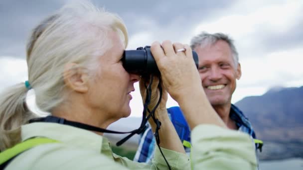 Happy Retired Caucasian Couple Binoculars Enjoying Vacation Hiking Remarkables Lake — Stock Video