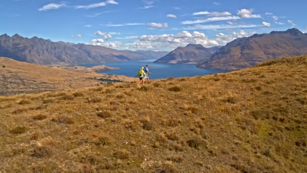 Aerial Drone Active Retired Caucasian Couple Rucksacks Enjoying Trekking Remarkables — Stock Video