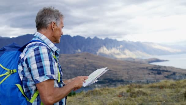 Dopasowanie Kaukaska Starszy Mężczyzna Plecakiem Planowania Podróży Widok Mount Aspiring — Wideo stockowe