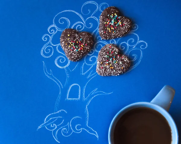 Coffee art. Picture of a picture of a tree invented and painted with his own hands decorated with biscuits with a cup of coffee. Composition with morning coffee, breakfast