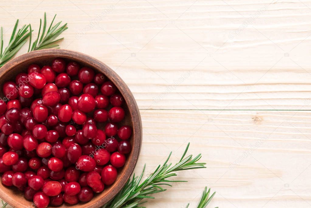 Cranberries on wooden background. Background with cranberries. Useful berries