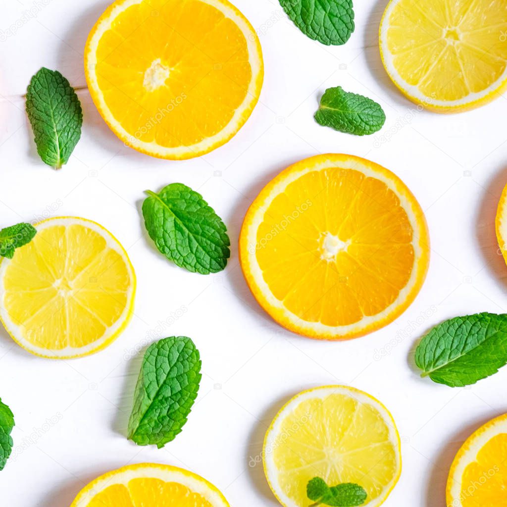 White background with lemon, orange slices and mint. Concept with fresh fruit. Lemon, Orange, Mint. View from above. Vitamin C Tea.