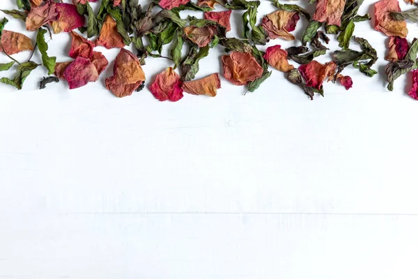Background with dried leaves and rose petals. Concept with dried rose petals. Photo above. Frame for the banner on the site with flowers