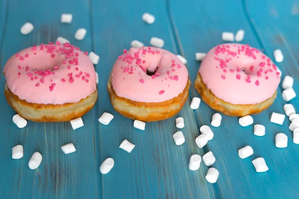 Fotoğraf Donuts mavi ahşap arka plan üzerinde. Tatlılar. Donuts blog için fotoğraf