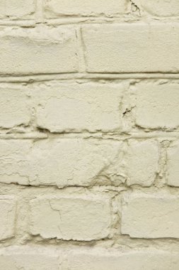 Boyalı olduğu eski tuğla duvar dokusu. Bir tuğla duvar dikey fotoğraf.