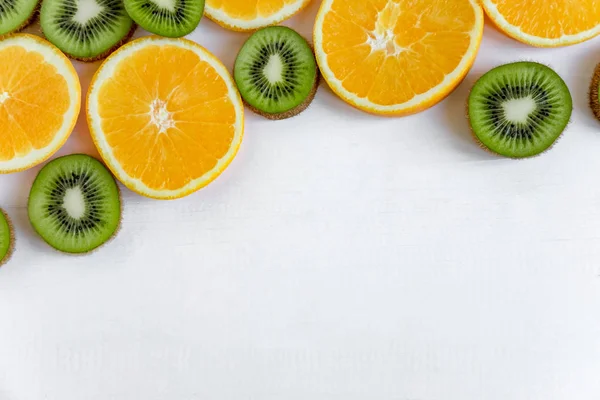 Fresh kiwi and orange sliced. Background for the profile, design, printing with fruit. The basis for the banner with orange and kiwi. Fresh and natkralnye vitamins. Healthy food. Flat lay, top view.