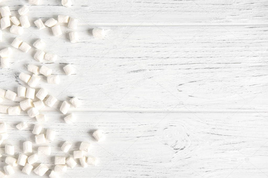 Background for banner with marshmallows on a white wooden background. Background with sweets. Background design for cafe, sweet shop