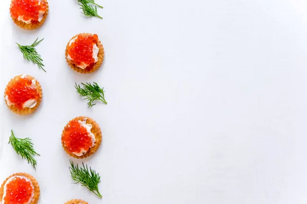 Frame for text with sandwiches with red caviar of salmon on the side. Infoblock. Sea banner. Luxury and wealth. Healthy food, protein food.