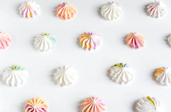 Pattern with sweets on a light background. Background with meringue. Basis for a banner with sweets — Stock Photo, Image