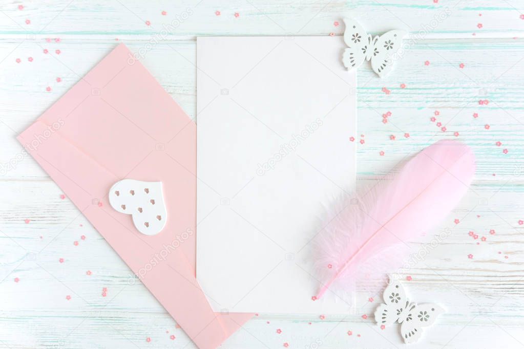Frame for greeting card text. Banner with envelopes, pen and a postcard on a white wooden background. Layout design basis for greeting card mom, girl, bride. Flat lay, top view.