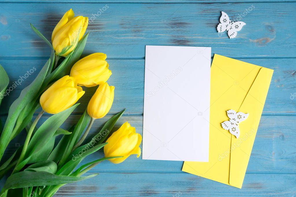 Mock up blank with flowers on a white background. Yellow tulips with copysceis. Frame for text with flowers. View from above