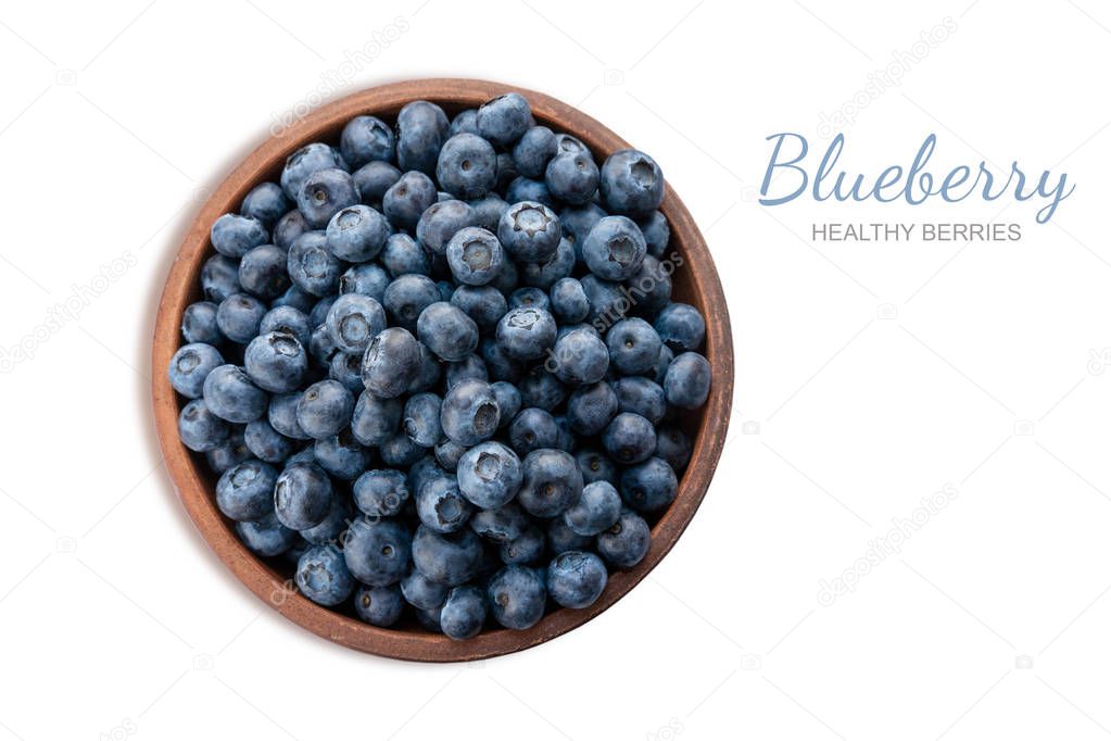 Closeup blueberry berries in a clay plate isolated on white background. Photo of blueberry for designers on the banner. Useful berries for sight