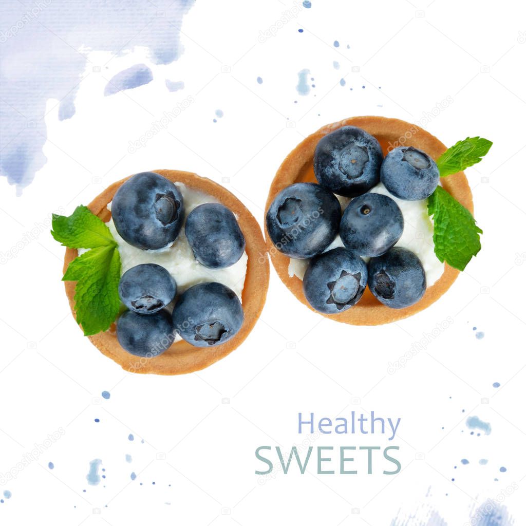 Tartlet with blueberries on a white background with watercolor pattern. Conceptual photo of useful sweets with berries. Design dishes for menus, flyers and discount coupons
