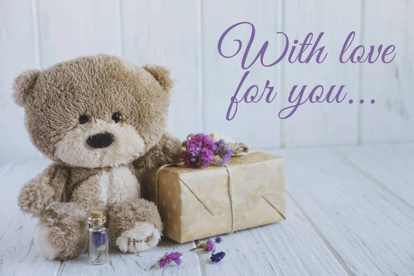 With love for you. Greeting card for a loved one, mom, dad, son and daughter. Vintage valentine card design with teddy bear, gift box and lilac flowers