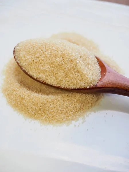 Brown powdered sugar in a spoon