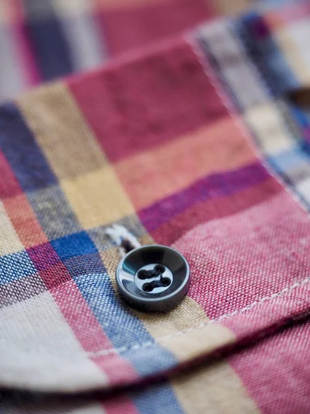 Red, blue, white checkered shirt and button