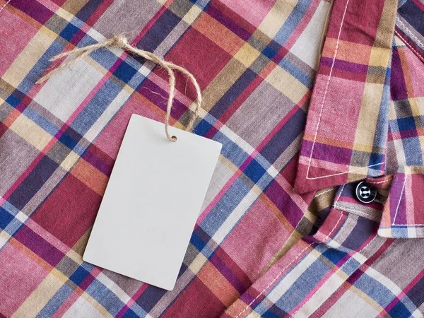 Red, blue, white checkered shirt and  Clothing label