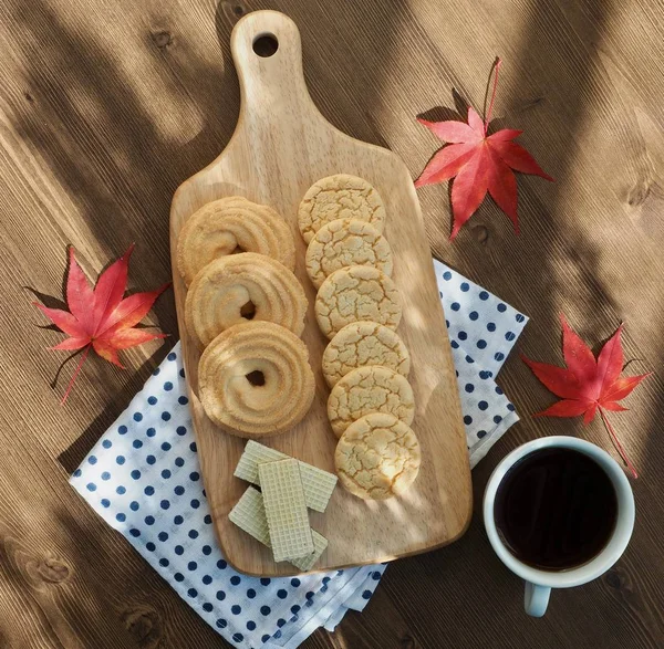 Butter cookies, chocolate cookies, coffee and maple leaves