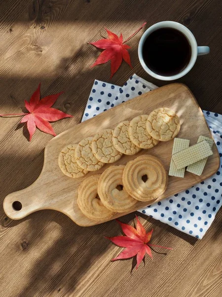 Butter cookies, chocolate cookies, coffee and maple leaves