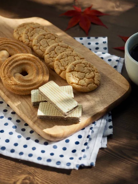 Butter cookies, chocolate cookies, coffee and maple leaves