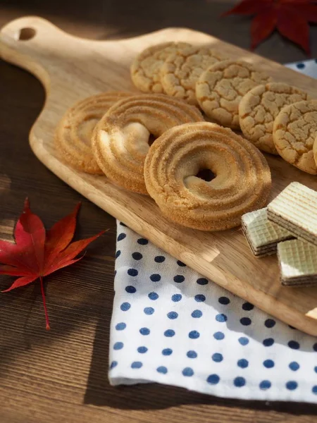 Butter cookies, chocolate cookies, coffee and maple leaves
