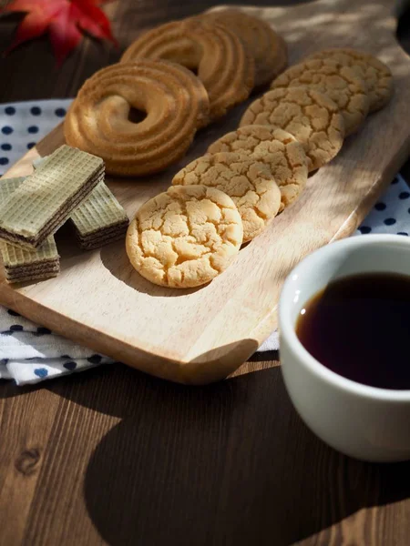 Butter cookies, chocolate cookies, coffee and maple leaves