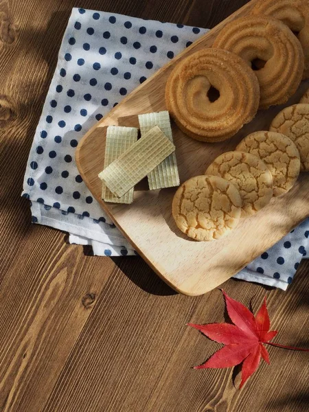 Butter cookies, chocolate cookies, coffee and maple leaves