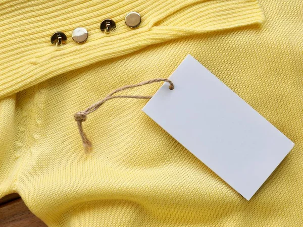 Yellow spring sweater and clothing label