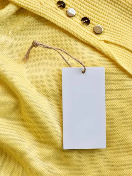 Yellow spring sweater and clothing label