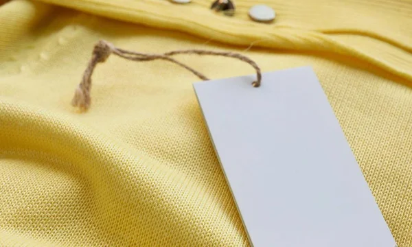 Yellow spring sweater and clothing label