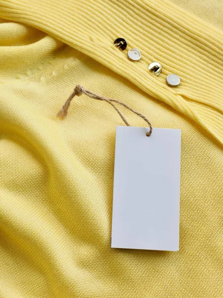 Yellow spring sweater and clothing label