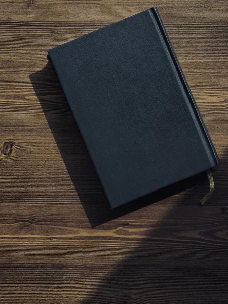 Wooden board and black book