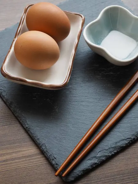 Steamed eggs and salt and chopsticks