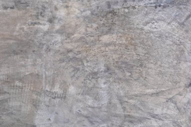 Arka planda veya duvar kağıdında çatlaklar olan kirli, gri beton bir duvarın dokusu