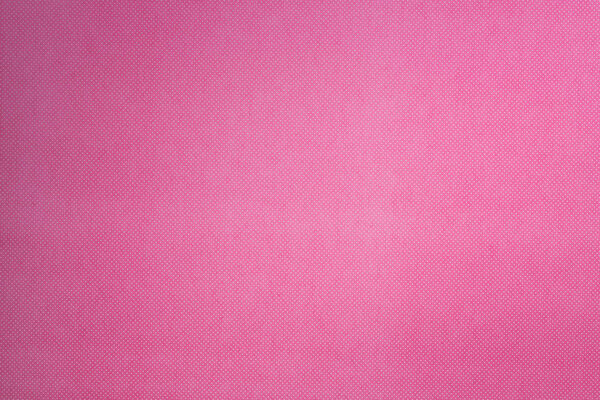 top view of pink surface with tiny white polka dot pattern for background