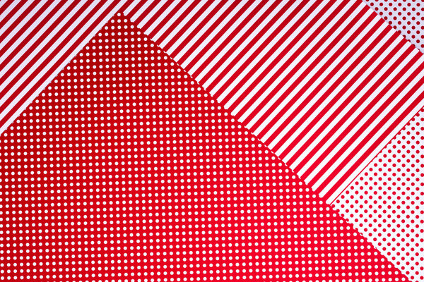 top view of red and white surface with polka dot pattern and stripes for background