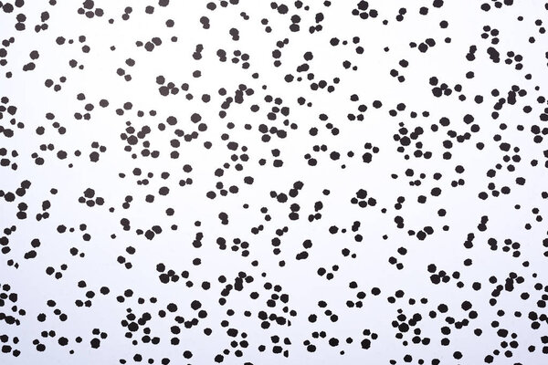 top view of white surface with black blots for background