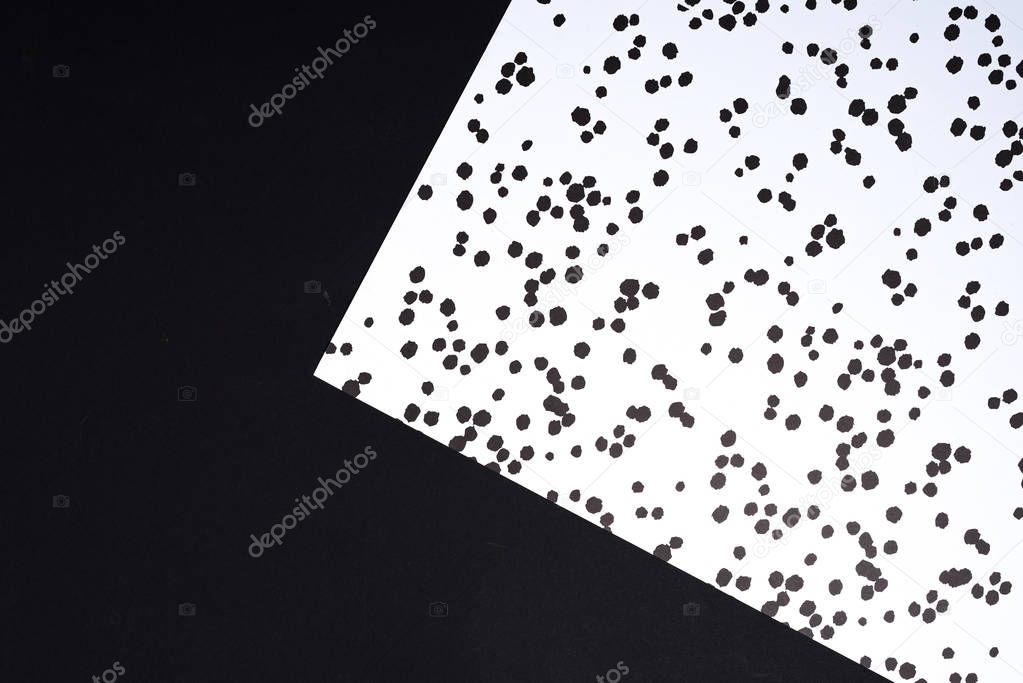 top view of black and white geometry composition with ink blots for background