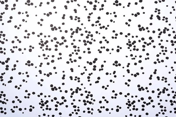 Top view of white surface with black blots for background — Stock Photo