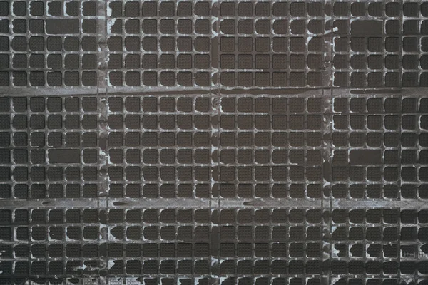 Top view of black plastic grid for background — Stock Photo