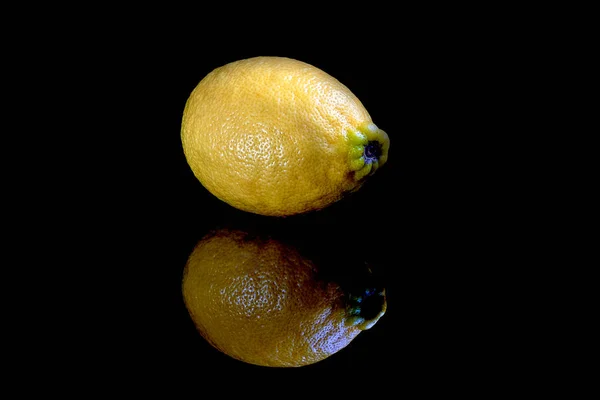 Plano de limones enteros y cortados en rodajas aislados sobre fondo negro — Foto de Stock