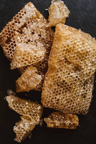 Elevated view of honeycombs on black table — Stock Photo