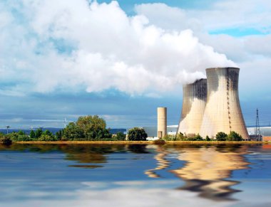 Nuclear power station in service at the edge of a river.              clipart