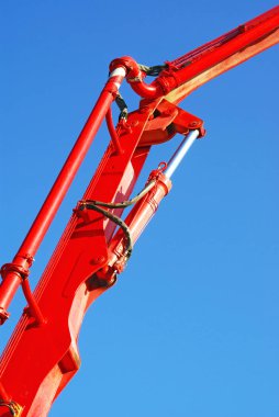 Mavi bir gökyüzü üzerinde kırmızı hidrolik silindir                